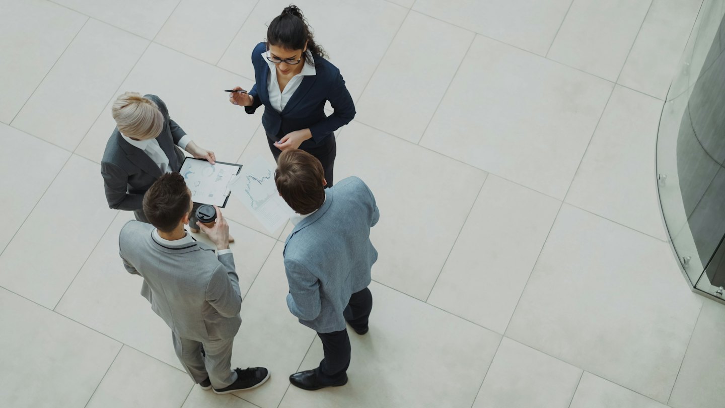 Business professionals collaborating over charts in a modern office.
